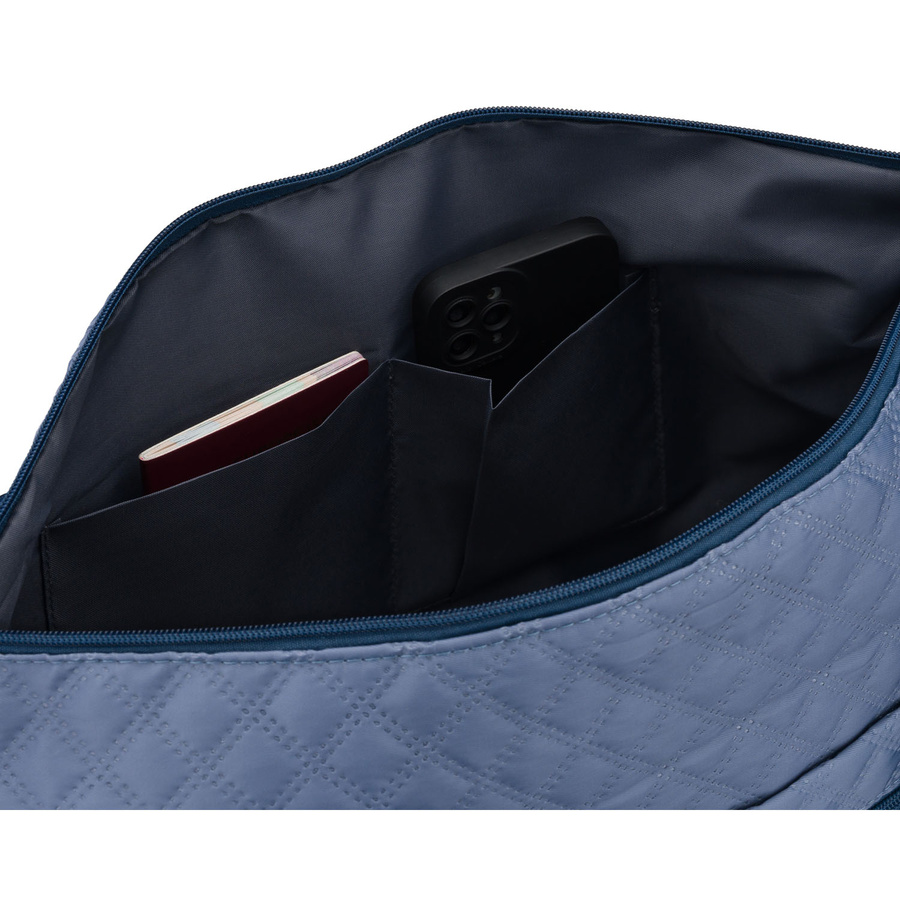 Treningowa torba wykonana z poliestru w niebieskim kolorze, wyposażona w uchwyt na walizkę - Peterson